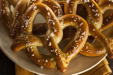 Pretzel com - Dec 20, 2017 · When the water is boiling, slowly add the baking soda. Boil the pretzel bread one portion a time in the soda bath for 60 seconds on each side. Use a slotted spoon to remove it from the bath and place it on the prepared baking sheet. Immediately sprinkle with coarse sea salt and repeat with remaining dough.. 